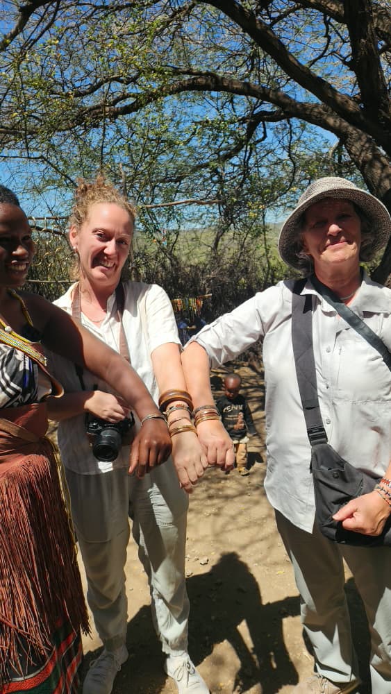 Guests comparing brass bracelets forged by Datoga blacksmiths